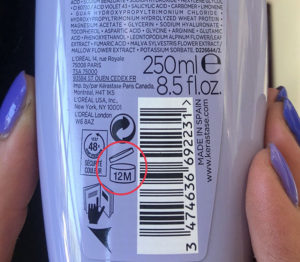 a shampoo bottle with the shelf life circled in red