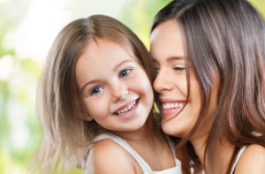 Mother and daughter hugging and smiling for blog post on back to school hair