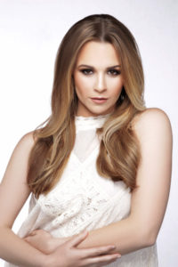 woman with light brown hair and soft waves