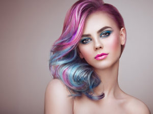vibrant pink and blue hair on a model for the best hair coloring salon in canton Georgia article